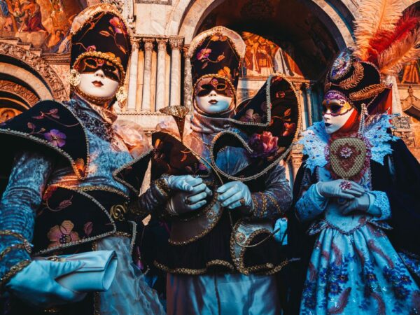 people wearing costumes in st marks square for venice carnival