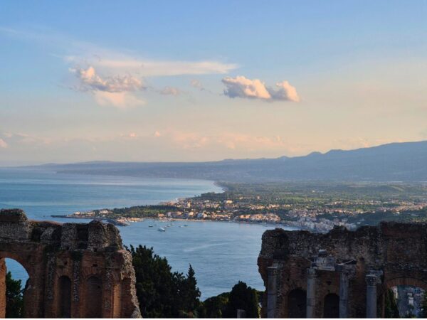 discover sicily view of coast through top of taormina greek theater