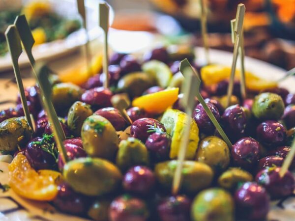 mix of purple and green olives on a plate for aperitivo