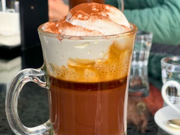 close up view of glass with bicerin turin hot chocolate coffee and cream