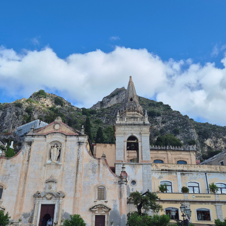 Buildings in front of hills and a blue sky