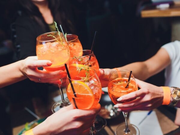 italian spritz cocktails glasses being clunked together