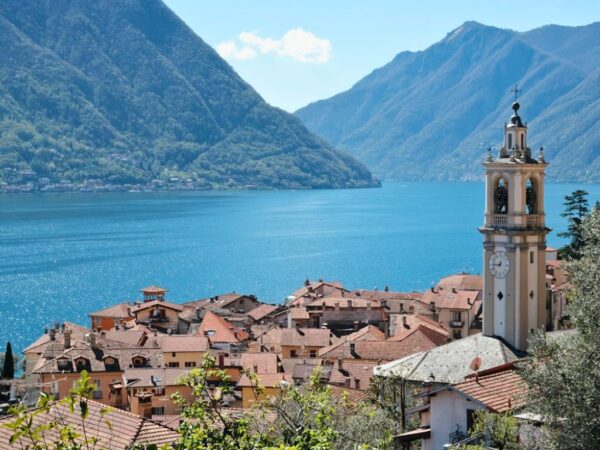 view of lake como water and mountains from como town in region of lombardy italy