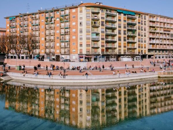 view of darsena port pedestrian area, with water reflecting the building above