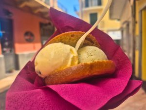 gelato scoops inside brioche bun on pink napkin