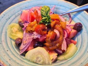panzanella salad topped with vegetables
