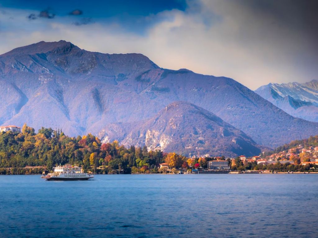 unexpected summer escapes view of stresa town on lake maggiore with mountains behind